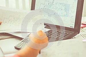 Close up of engineers hands working on table, he drawing project sketch in construction site or office