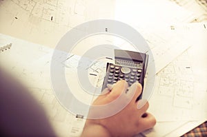 Close up of engineers hands working on table, he drawing project sketch in construction site or office