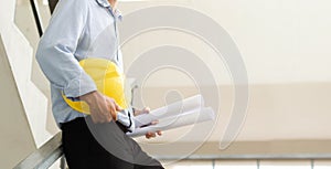 Close-up of engineers working on a construction site with blueprints, lighting, planning, engineering