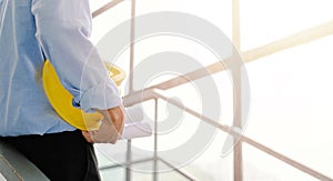 Close-up of engineers working on a construction site with blueprints, lighting, planning, engineering