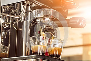 Close-up of espresso pouring from coffee machine at the morning