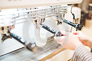 Close-up of espresso pouring from coffee machine. Professional coffee brewing