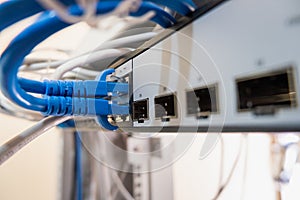 Close-up of Ethernet cable pluged on network switch, UTP cabling and computer network photo