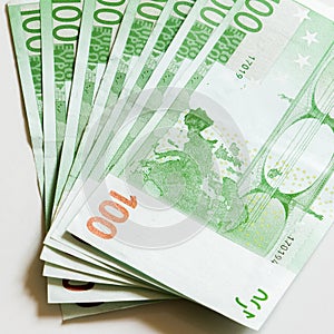 Close-up of 100 Euro banknotes isolated on white background. photo