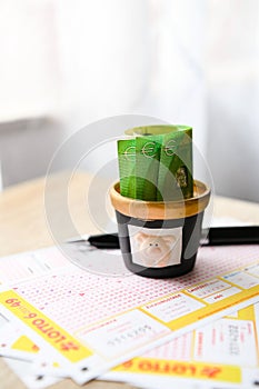 Close-up of euro banknotes and lottery tickets on the table