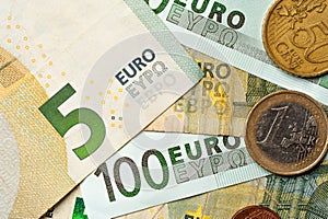 Close-up euro bills and coins lie next to each other