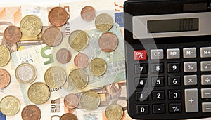 Close up of euro currency. coins, banknotes and calculator