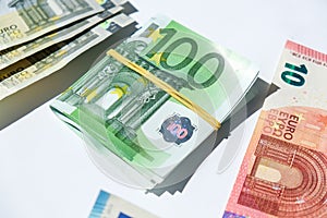 Close up of Euro money roll. Euro banknote set cash money - EU currency. Rolled with rubber euro notes. Banknotes stacked on each