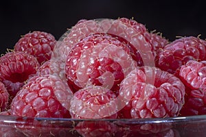 Close-up of European raspberry or red raspberry Rubus idaeus on black background