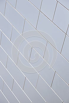 Close-up of even white tiled wall of building