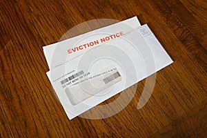 Close-up Of An Eviction Notice In Envelope on Desk