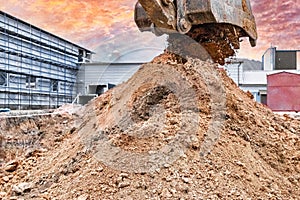 Close up of excavator bucket at construction site. The excavator is digging a trench for underground utilities. Construction