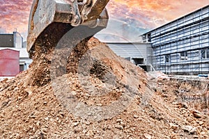 Close up of excavator bucket at construction site. The excavator is digging a trench for underground utilities. Construction