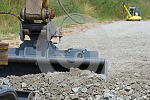 Excavator produces crushed stone planum photo