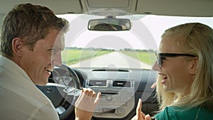 CLOSE UP: Excited boyfriend and girlfriend dance and drive through country.