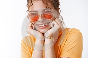 Close-up excited happy carefree playful redhead young girl wearing sunglasses orange t-shirt chilling seaside during