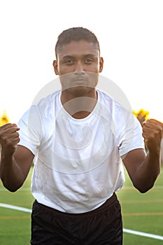 Close up of excited soccer player celebrating a goal.