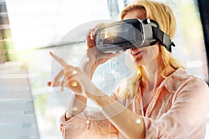 Close up of excited woman wearing virtual reality glasses