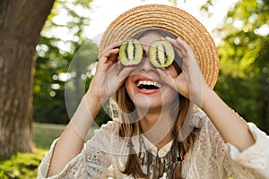 Close up of excited young girl in summer hat spending time at the park,