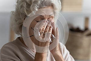 Close up exhausted mature woman suffering from eye strain