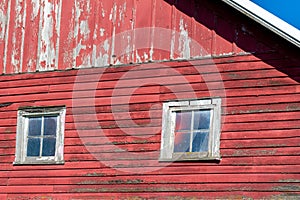 Close up exterior view of old weathered red 19th Century wooden barn