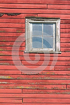 Close up exterior view of old weathered red 19th Century wooden barn