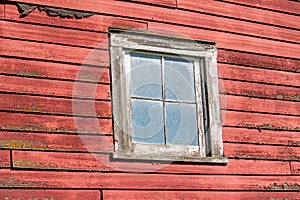 Close up exterior view of old weathered red 19th Century wooden barn