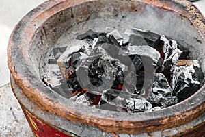 Close-up extinguish fire coal in stove