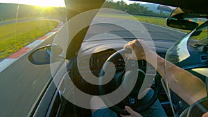 CLOSE UP: Extreme racer preparing for a race by driving around the raceway.