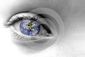 Close up of an eye with the earth in its iris