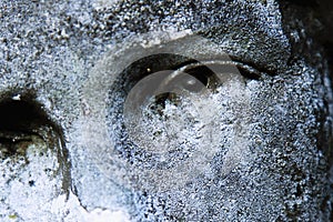 Close up eye view of Virgin Mary. Vintage statue of sad woman in grief Religion, faith, suffering, love concept