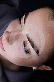 Close-up of the eyebrow of a beautiful female model after the procedure of permanent make-up of the eyebrows