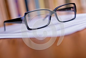 Close up Eyeglasses on Top of White Papers