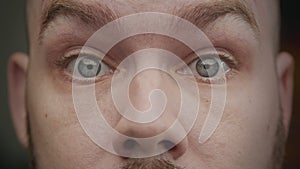 Close-up eyes of an adult caucasian man surprised with his eyebrows pulling up