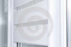 Close up of fabric window roller, close system day and night