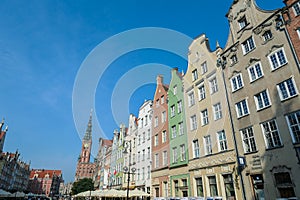 A close up of the facades of tall building in the middle of Old Town in Gdansk, Poland. The buildings have many bright colors