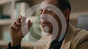 Close up face African American man ethnic thoughtful puzzled businessman pensive business entrepreneur office manager