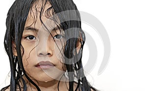 Close up face of Asian child girl on white background, wet face and hair, water drops on face and hair, unpredictable or cold