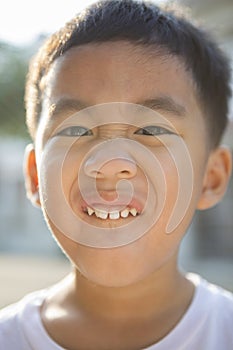 Close up face of asian children showing milk tooth