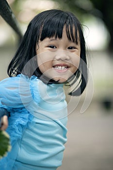 Close up face asian girl children toothy smiling face happiness emotion looking to camera