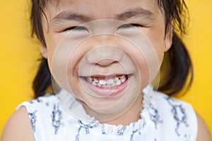 Close up face of asian kid toothy smiling facial face with happi