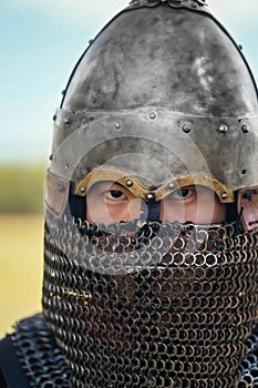 Close up face of asian warrior in eastern medieval helmet.