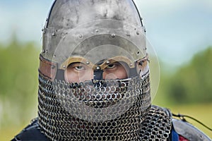 Close up face of asian warrior in eastern medieval helmet.