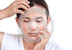 Close up face of asian woman with nose plastic surgery for beauty and cosmetic conept, white background