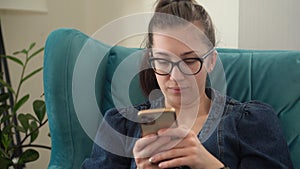 Close up Face Authentic Young Woman Chatting On Phone In Living Room. Writing Searching Using IT. Happy smiling Lady