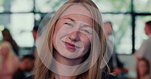 Close-up face of beautiful smiling happy young businesswoman, team company boss posing at busy office slow motion.