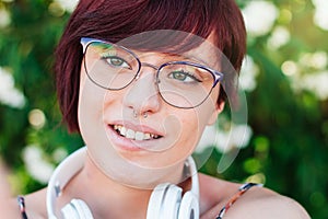 Close-up of the face of a beautiful woman with glasses and pretty green eyes