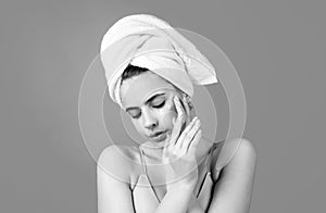 Close up face of beautiful young woman with bath towel on head. Beautiful woman face isolated on studio. Natural