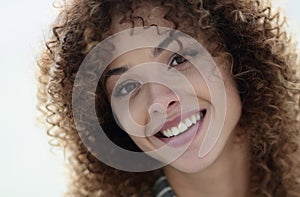 Close-up face of beautiful young woman with curly hair