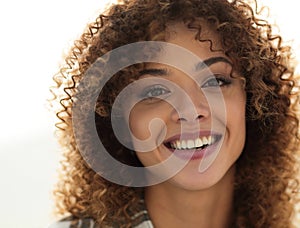 Close-up face of beautiful young woman with curly hair